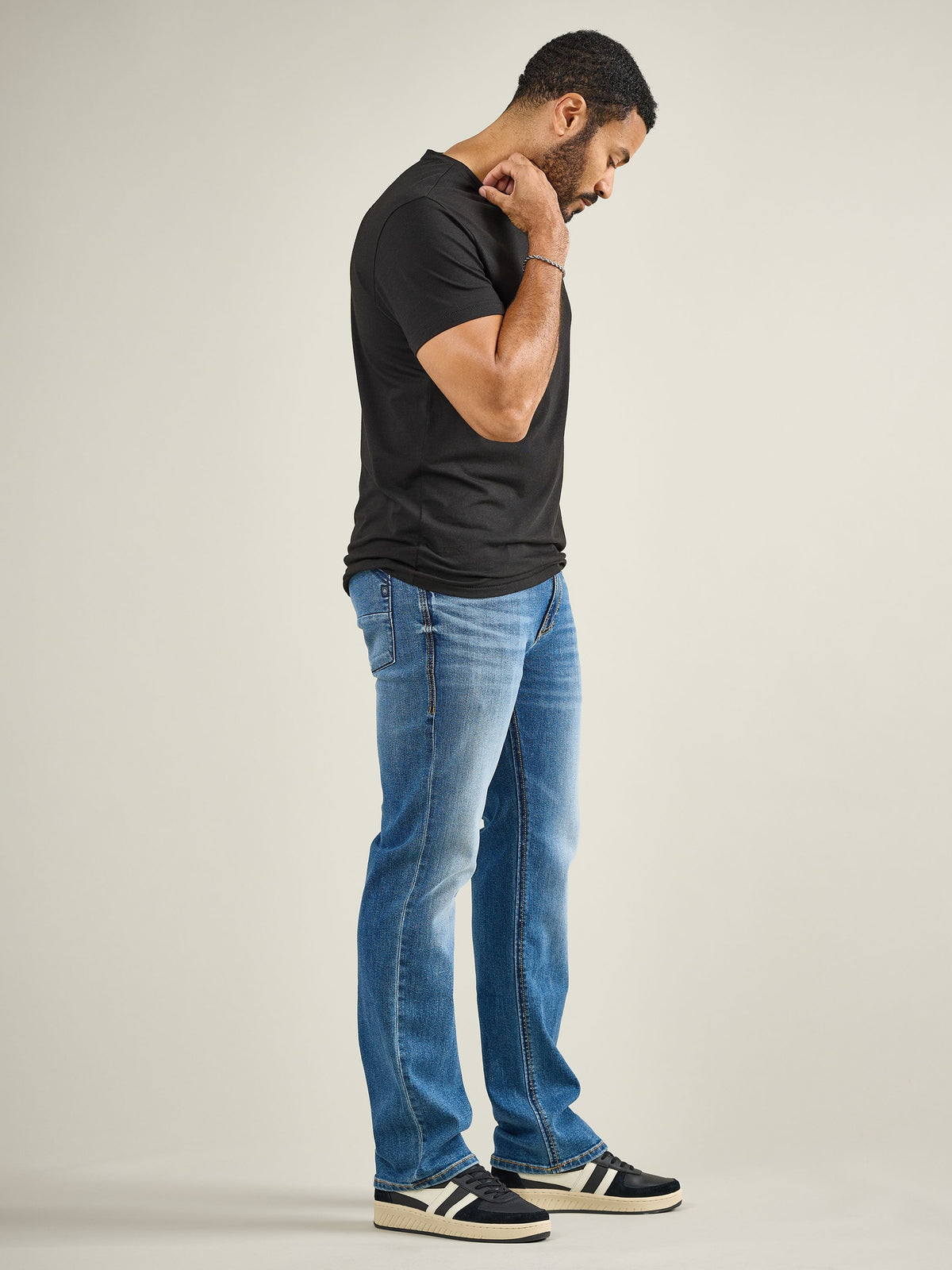 Side profile view of Rock & Republic Henlee bootcut jeans in Makes Sense highlighting classic sculpted bootcut silhouette.