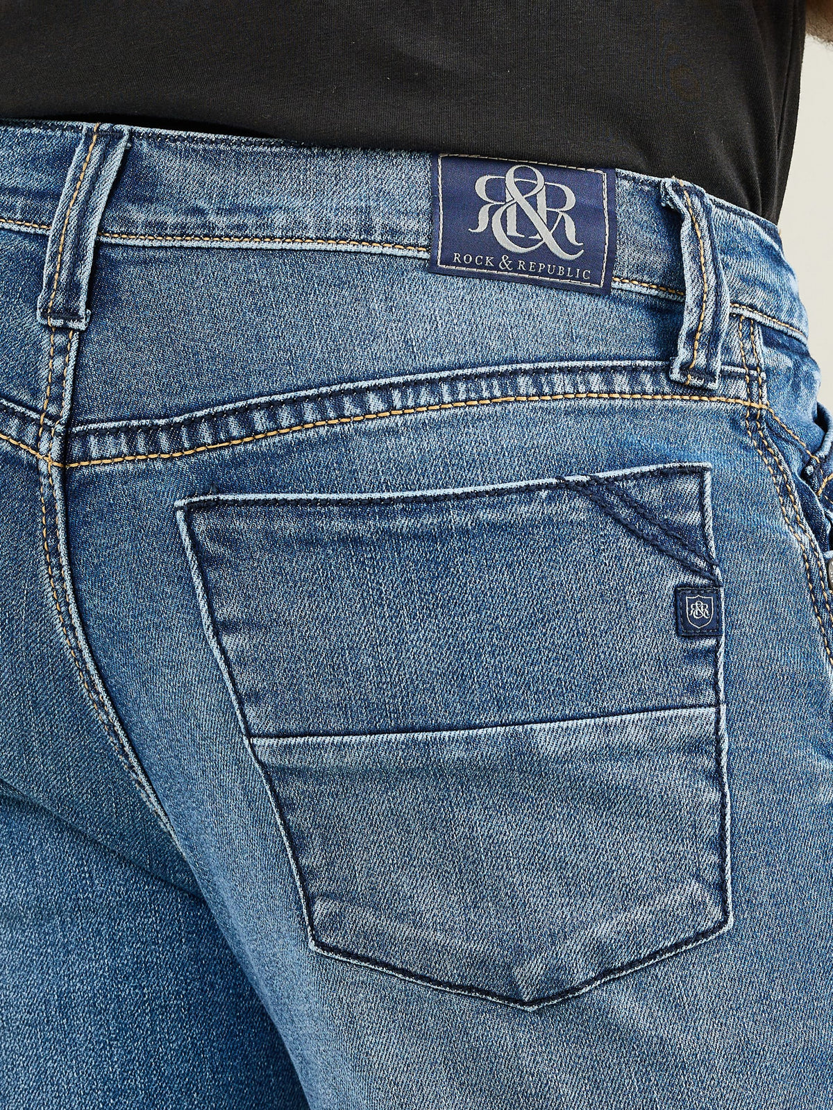 Detailed back pocket view of Rock & Republic Henlee jeans in Makes Sense showing embroidered waist patch and crest logo tab.