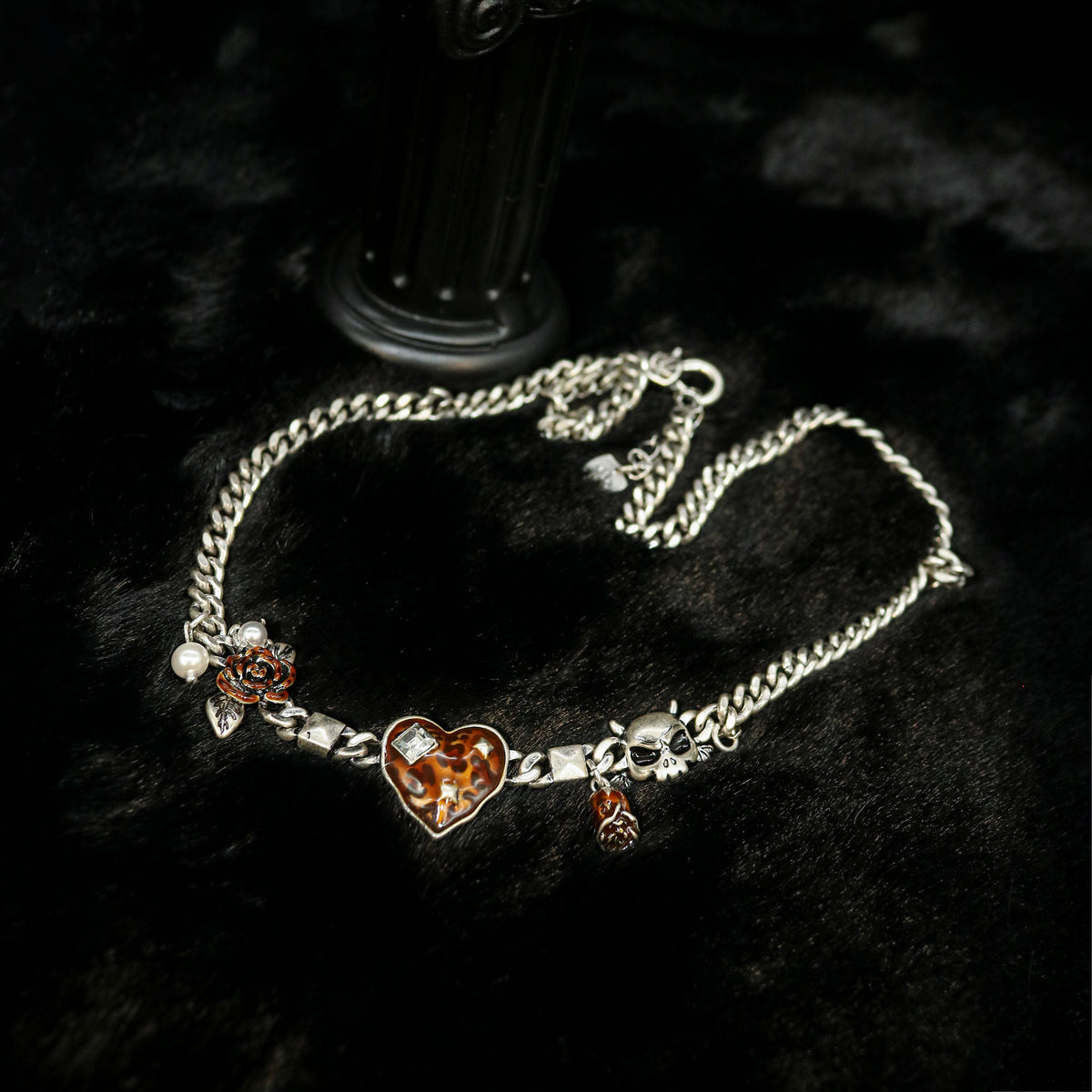 Flat lay view of Rock & Republic heart stone effect charm link wristband in Antique Silver showing full chain and charms.