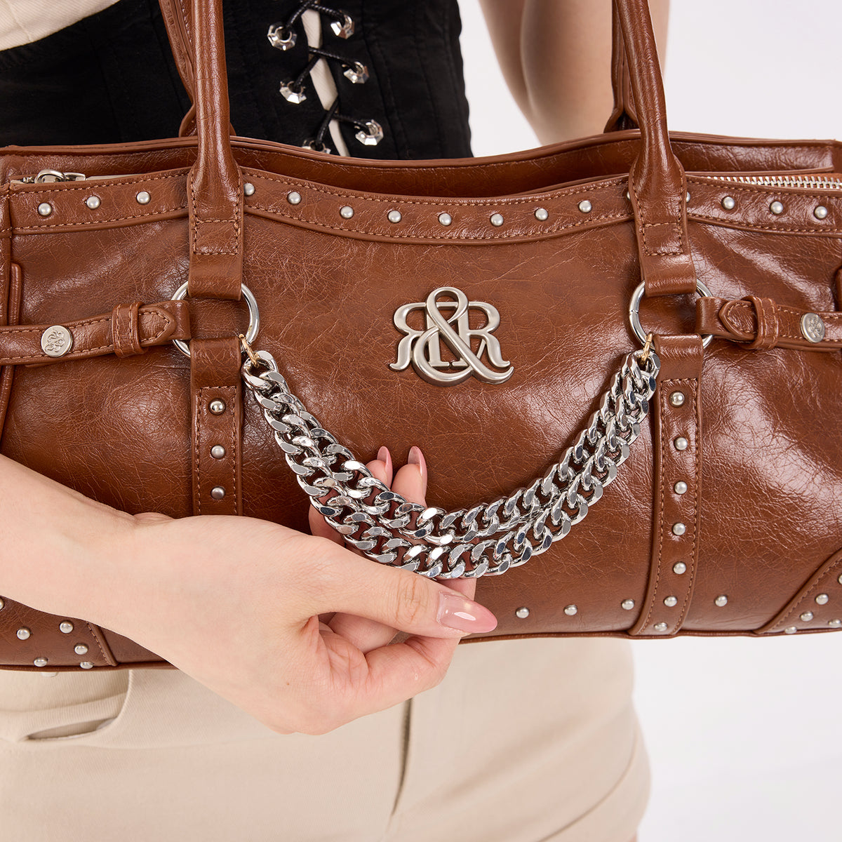 Rock & Republic Studded Draped Chain Shoulder Bag in Dark Brown PU close-up highlighting draped chain and boston frame.