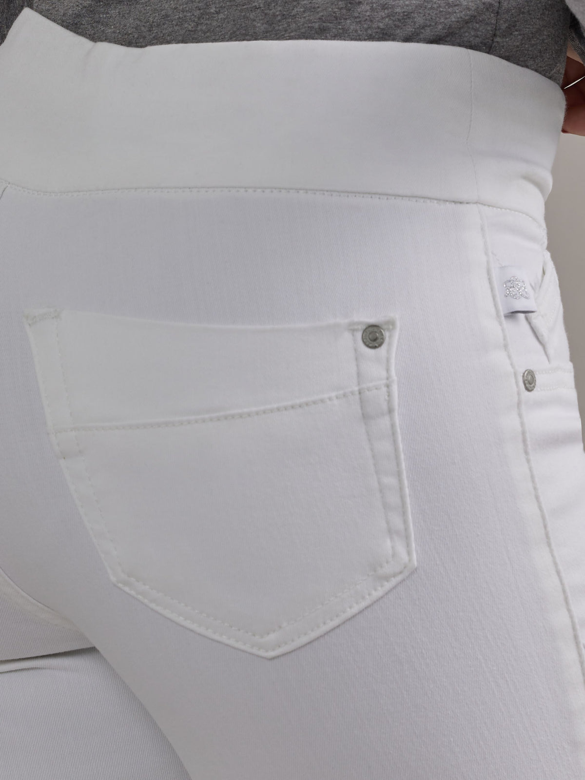 Macro view of Rock & Republic Women's Fever Legging in Antidote showing rear patch pocket and metallic rivet detail.