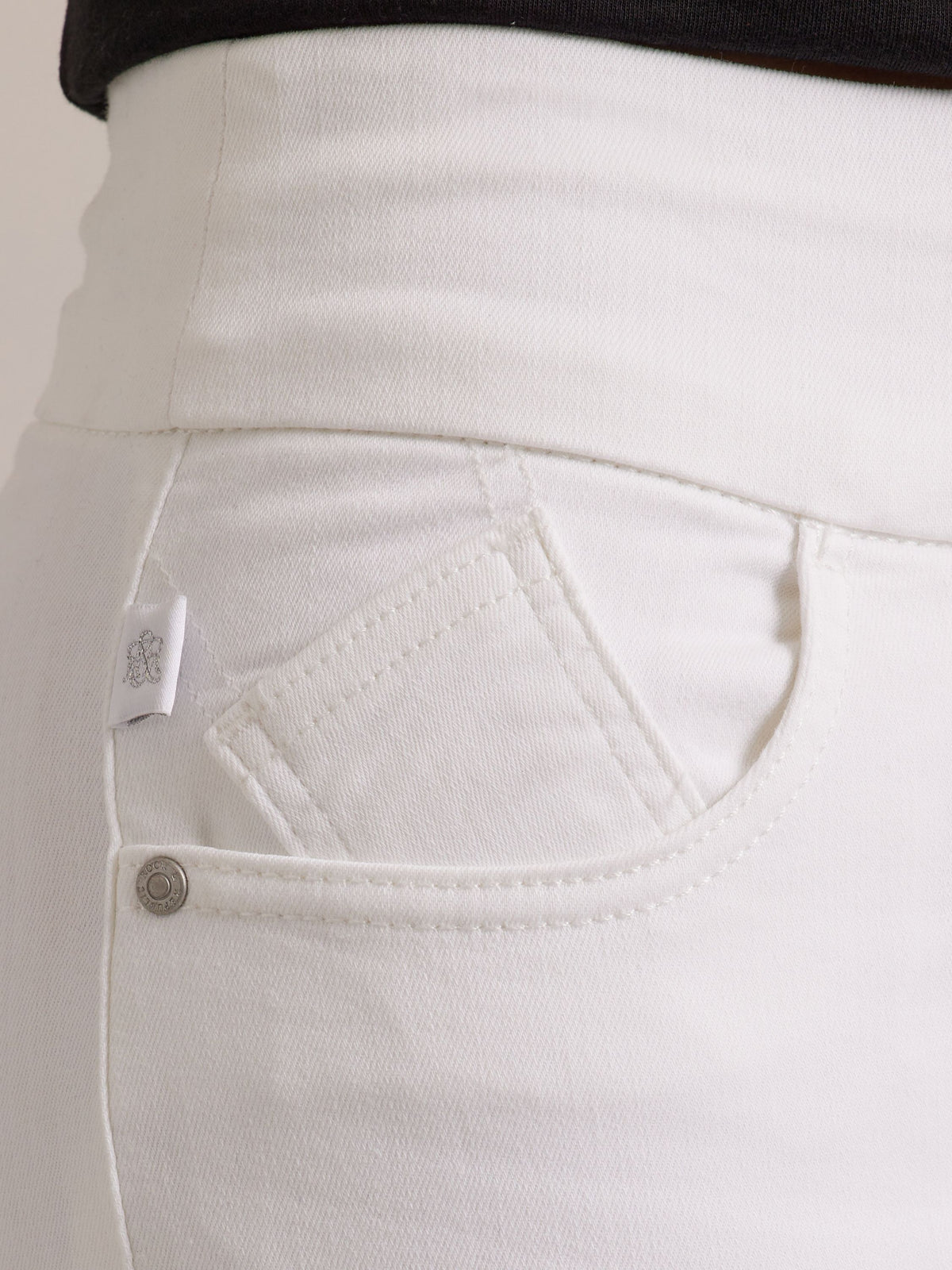 Front pocket detail of Rock & Republic Fever Pull-On Short in Antidote showing coin pocket, rivet, and white RR logo tab.