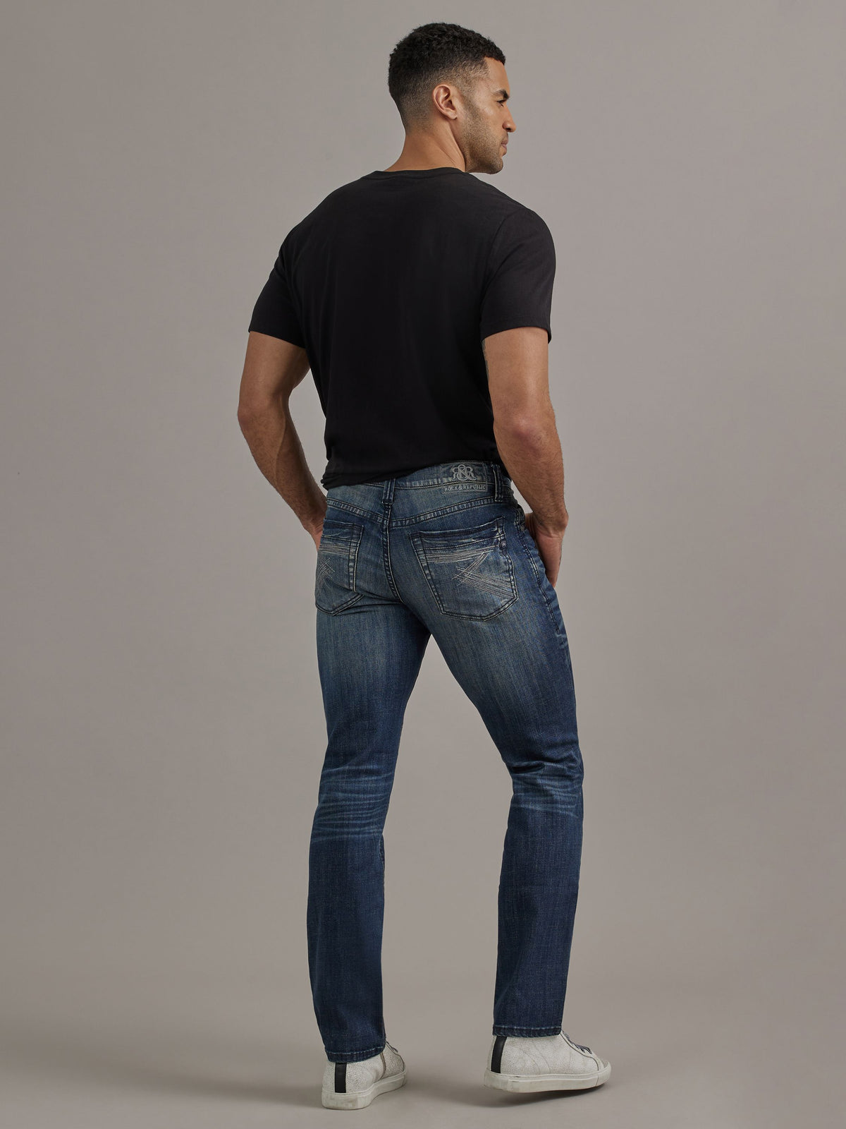Back full view of Rock & Republic Neil straight jeans in Street Cred showing rear pocket embroidery and straight leg fit.