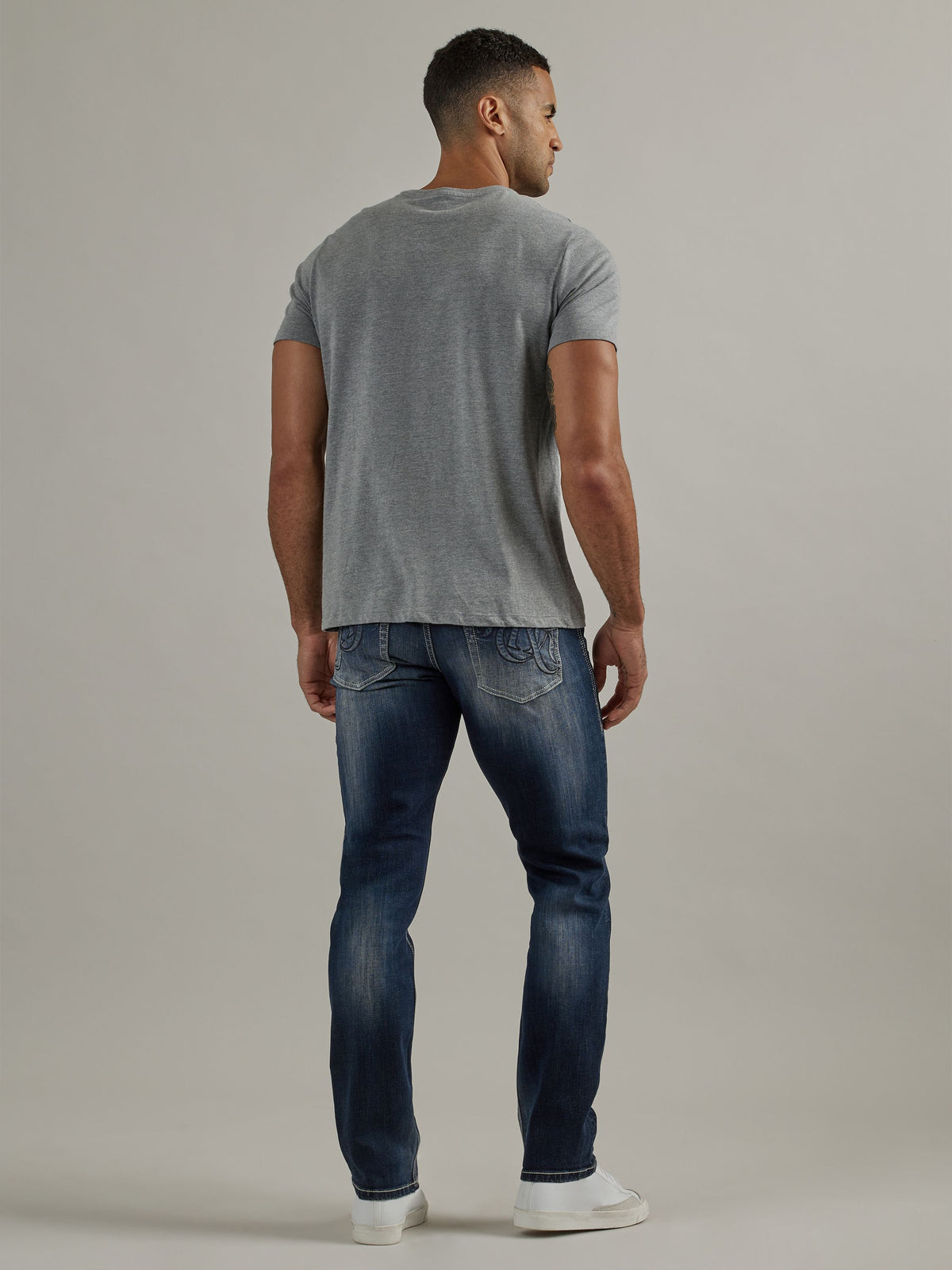 Back full view of Rock & Republic Colburg slim straight jeans in Mad Skills showing oversized R embroidery and rear fade.