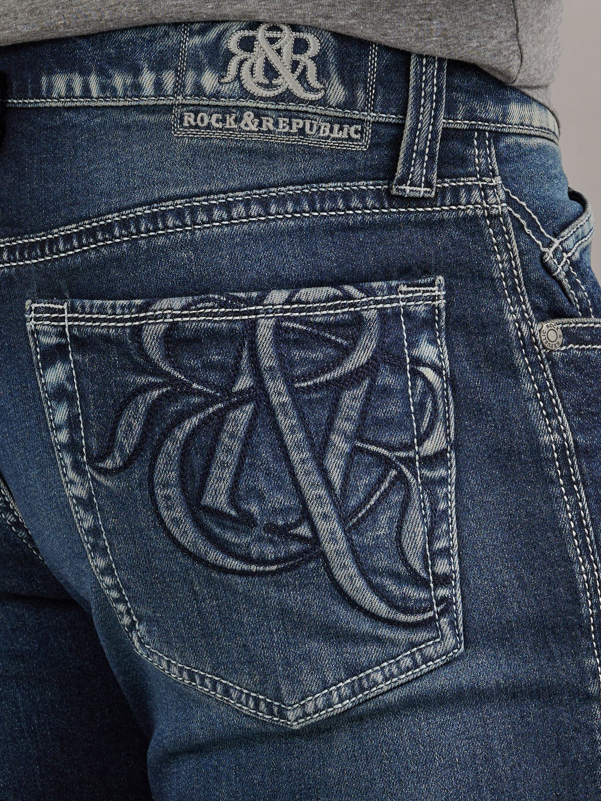 Close-up of Rock & Republic Grady jeans back pocket in On Point featuring signature oversized embroidered R logo.