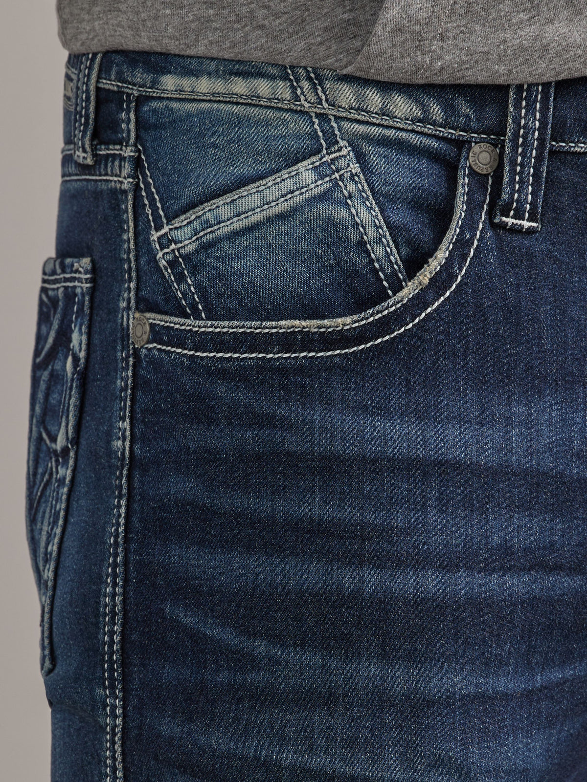 Detailed front waist view of Rock & Republic Grady jeans in On Point showing angled coin pocket and white topstitching.