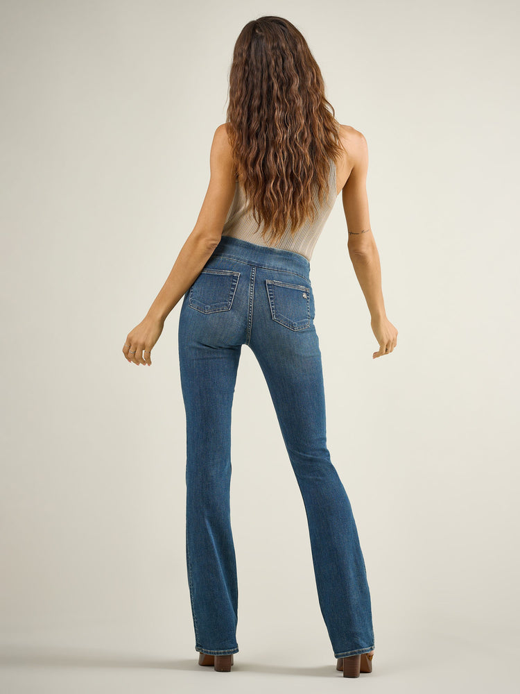 Back full view of Rock & Republic Fever pull-on bootcut jeans in Glamazon showing rear pockets and flattering bootcut shape.
