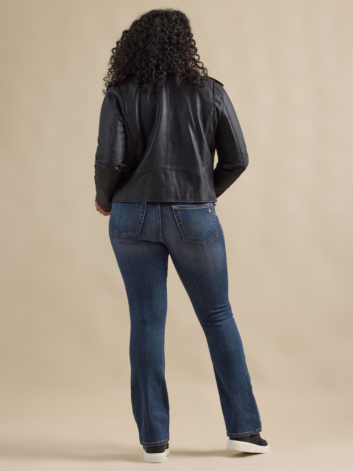 Back view of Rock & Republic Fever pull-on bootcut jeans in Glamazon on curve model showcasing flattering rear pocket fit.