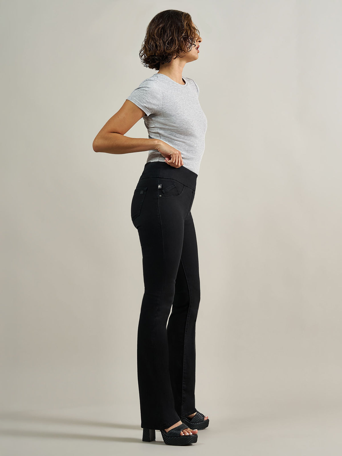 Side profile view of Rock & Republic Fever pull-on bootcut jeans in DNA showcasing smooth flat waistband and elongated fit.