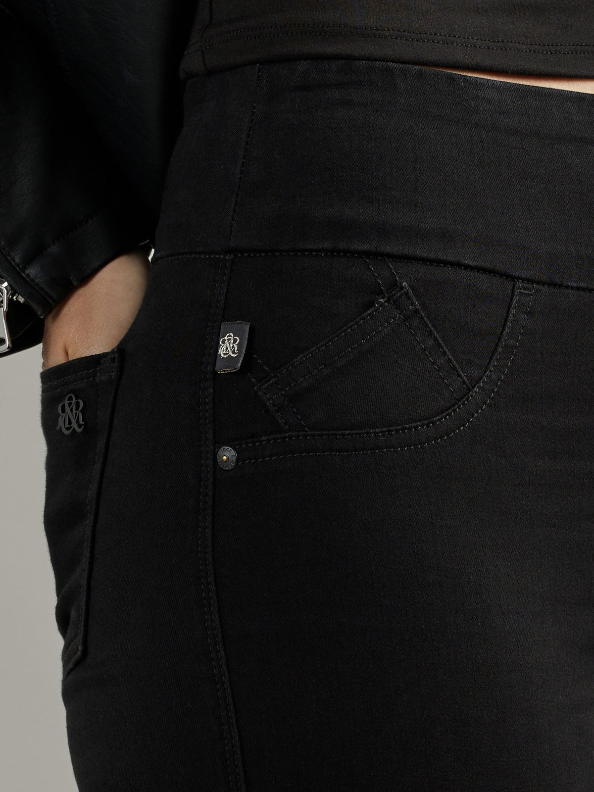 Detailed view of Rock & Republic Fever pull-on jeans in DNA highlighting wide comfort waistband and angled coin pocket.