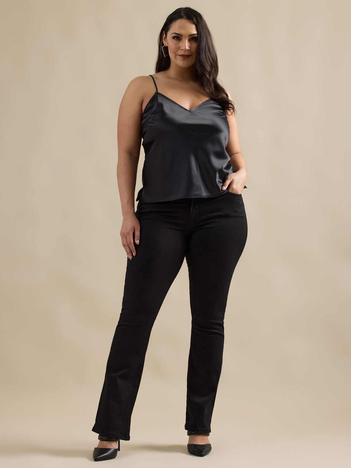 Front view of Rock & Republic Kasandra bootcut jeans in DNA on curve model showing sleek silhouette in deep black denim.