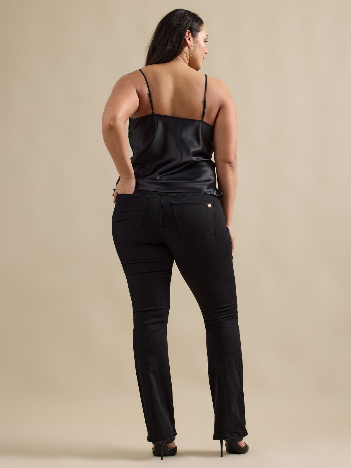 Back view of Rock & Republic Kasandra bootcut jeans in DNA on curve model highlighting flattering fit and bootcut hem.