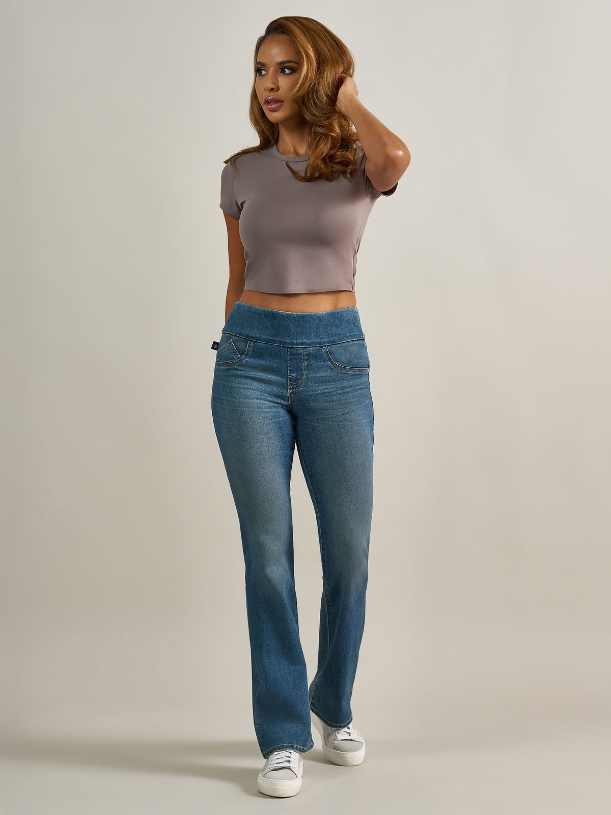 Front full view of Rock & Republic Fever pull-on bootcut jeans in That Girl featuring wide waistband and subtle whiskering.