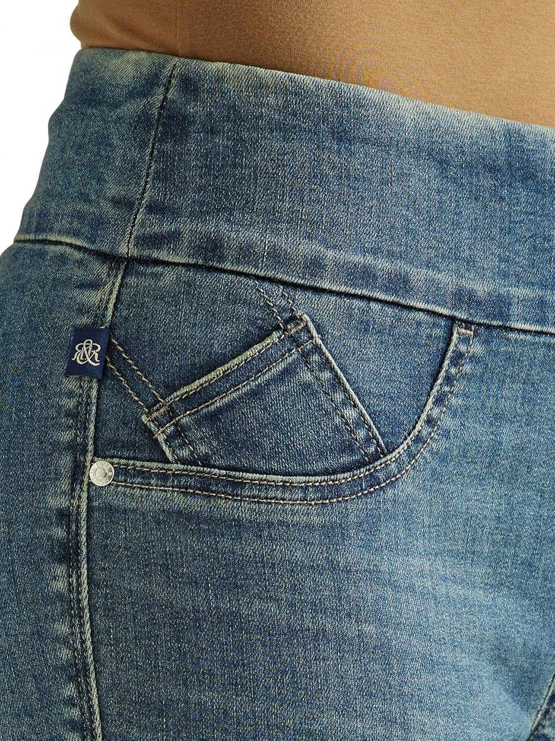 Detailed front waist view of Rock & Republic Fever pull-on jeans in That Girl showing angled coin pocket and blue RR tab.