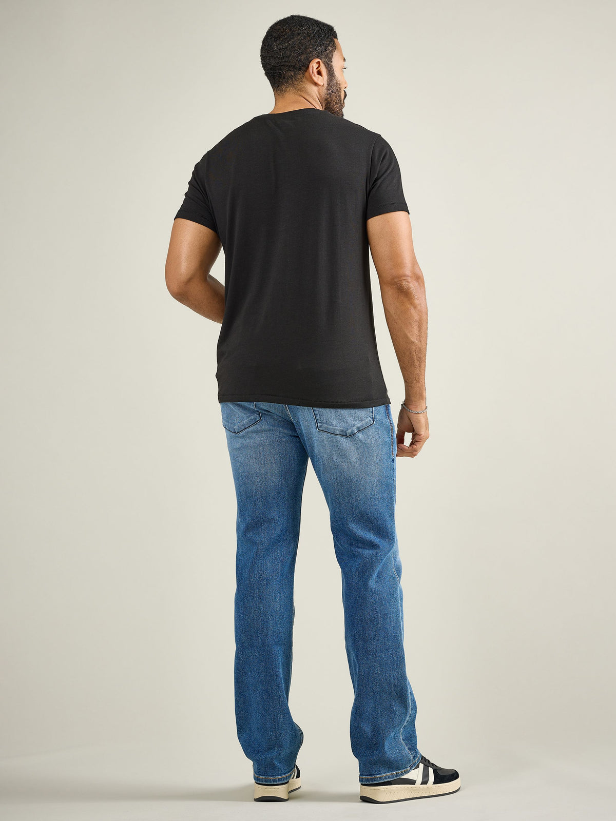 Back full view of Rock & Republic Henlee bootcut jeans in Makes Sense showing rear pocket details and classic flare hem.