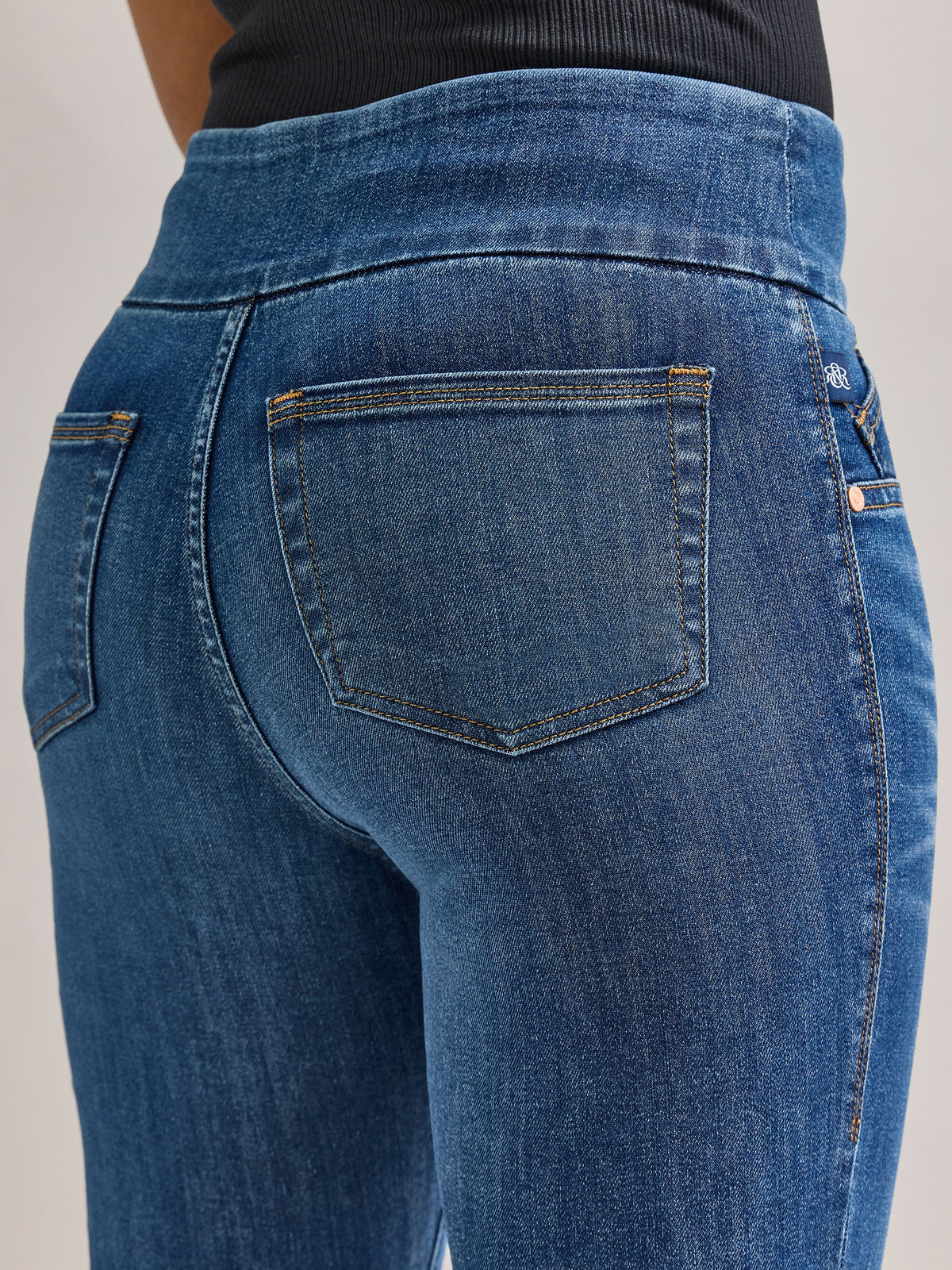 Rear side view of Rock & Republic Fever pull-on jeans in Heartfelt highlighting clean back pocket and contoured fit.