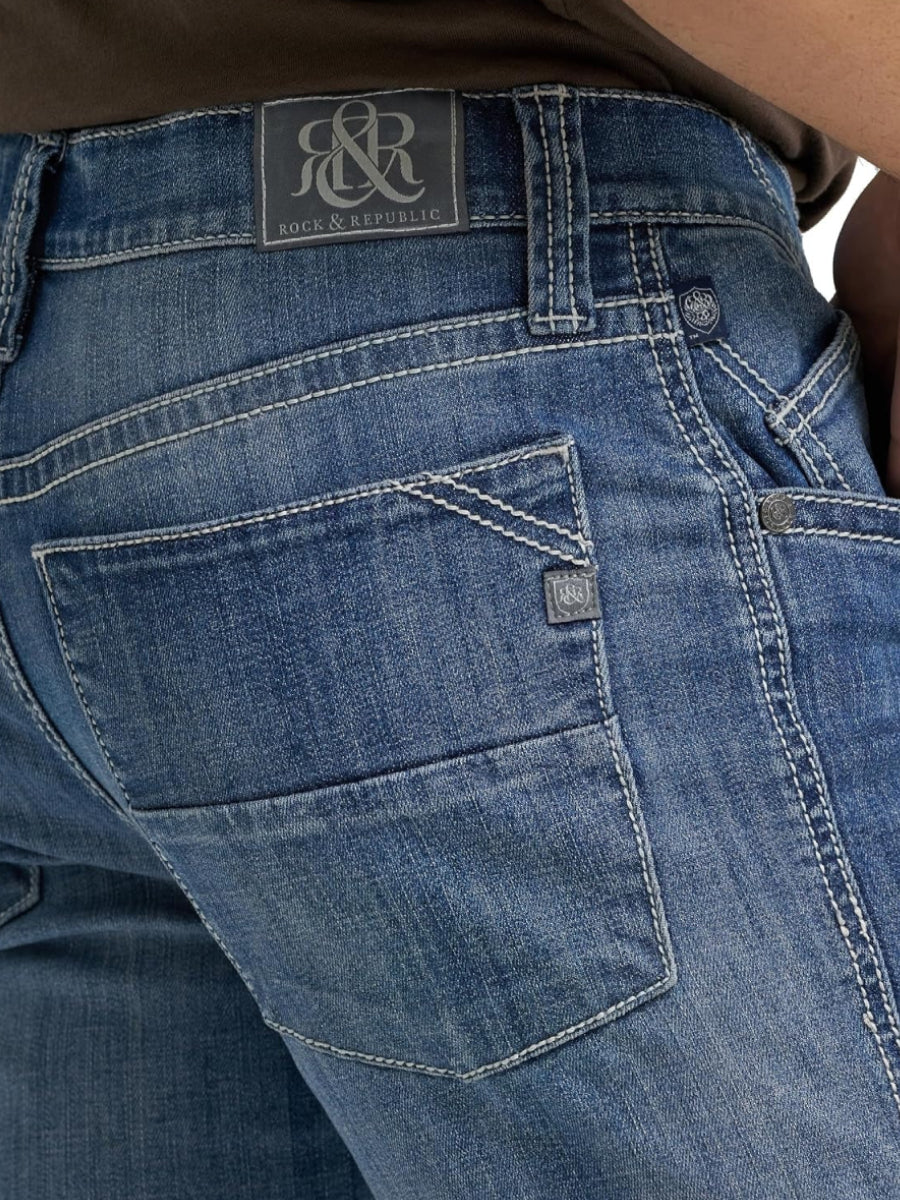 Detailed back pocket view of Rock & Republic Colburg jeans in Jet Stream showing contrast stitching and crest logo tab.