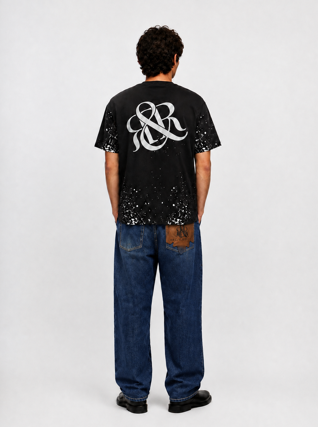 Baggy Jeans with Distressed Knee Details and Leather Back Patch