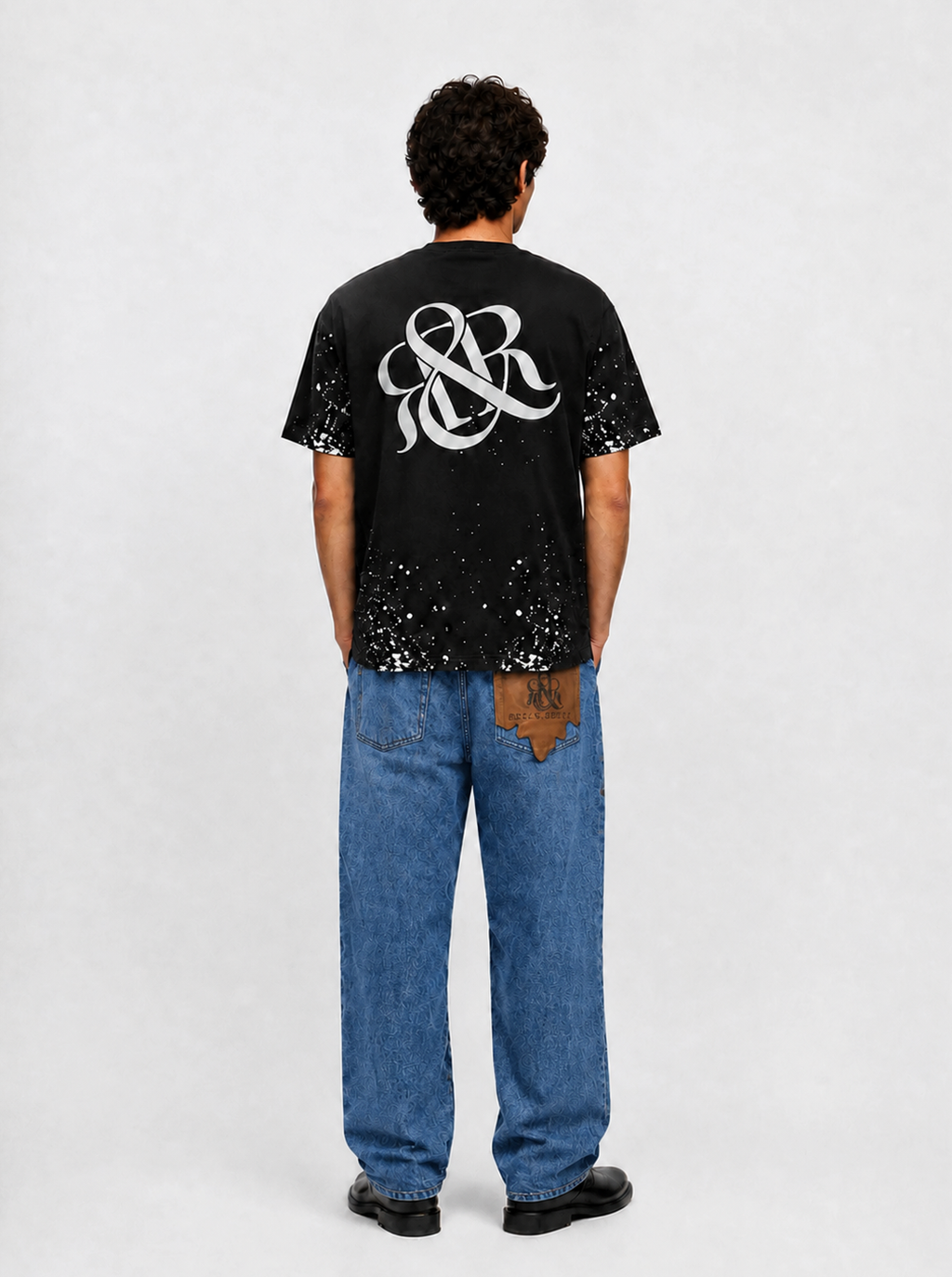 Baggy Jeans with Distressed Knee Details and Leather Back Patch