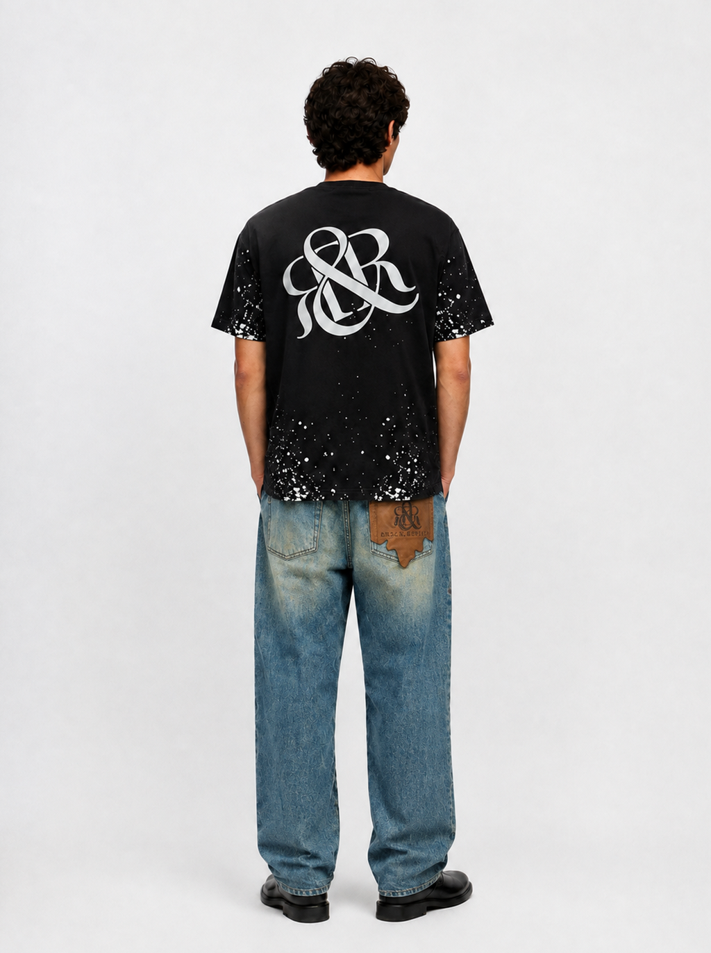 Baggy Jeans with Distressed Knee Details and Leather Back Patch