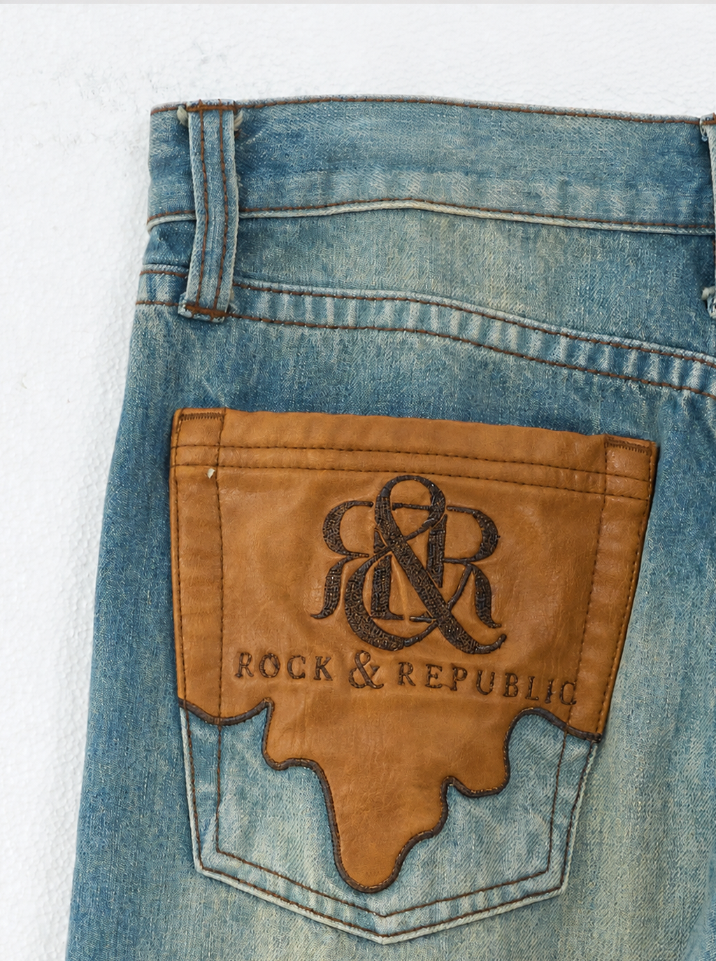 Baggy Jeans with Distressed Knee Details and Leather Back Patch