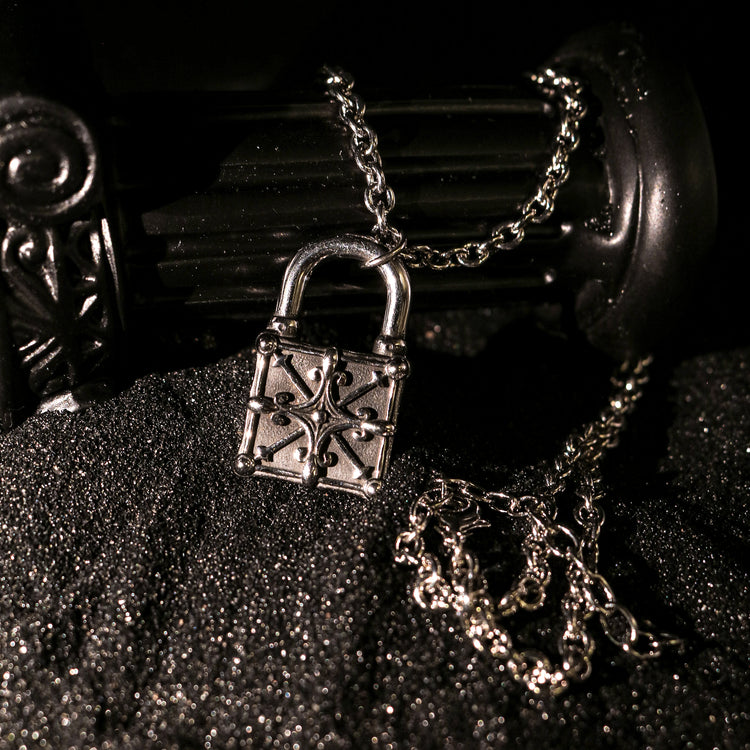 Close-up of Rock & Republic Iron Lock Padlock Chain Necklace in Silver showing ornate relief padlock and gleaming chain.