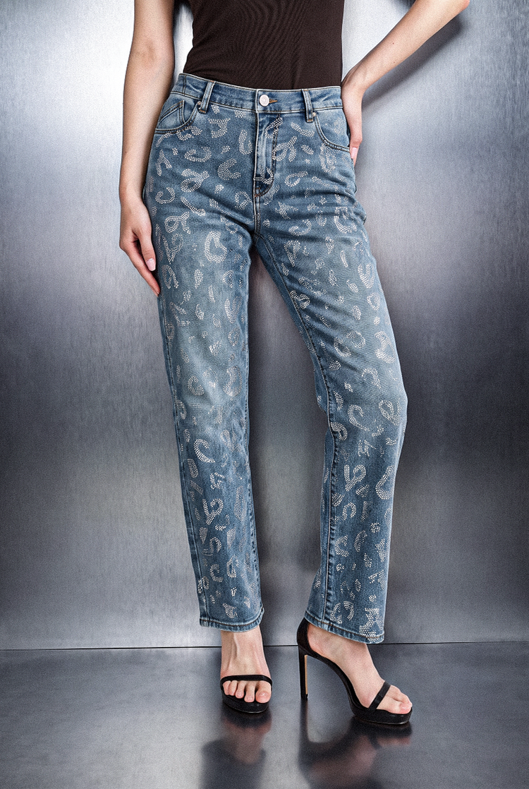 Front angle view of Rock & Republic Kaia straight jeans in Medium Blue featuring allover silver rhinestone leopard pattern.