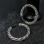 Top view of Rock & Republic Cubic Zirconia Orbit Circle Earrings in Silver with twisted pave hoops and latch-back clasp.