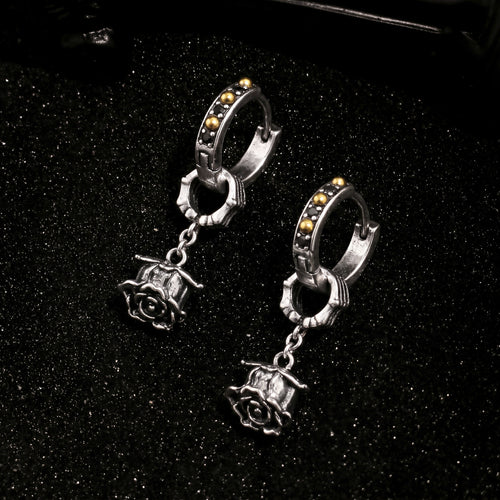 Top view of Rock & Republic Black Cubic Zirconia Rose Charm Hoop Earrings in Black with dark studded hoop and rose charm.