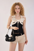Rock & Republic Studded Ruched Hobo Shoulder Bag in Black PU styled on model showing handheld studded hobo silhouette.