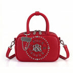 Rock & Republic Studded Logo Medallion Satchel Bag in Red PU leather with medallion and satchel silhouette.