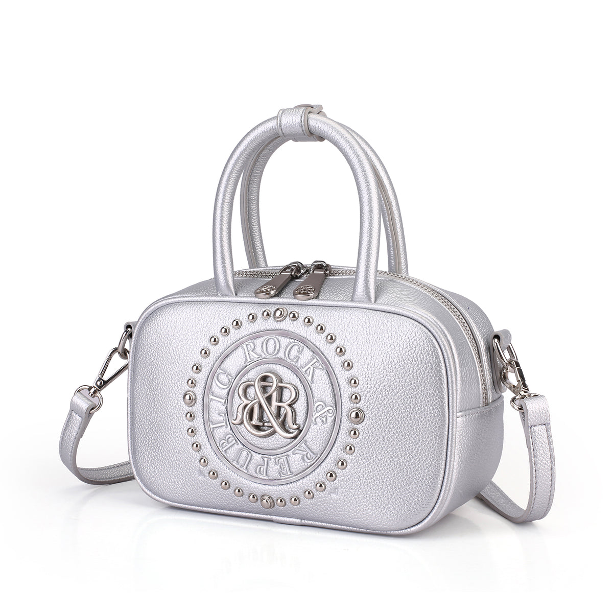 Rock & Republic Studded Logo Medallion Satchel Bag in Silver PU leather with medallion and satchel silhouette.