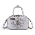 Rock & Republic Studded Logo Medallion Satchel Bag in Silver PU close-up showing medallion and satchel shape.