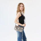 Rock & Republic Shield Logo Ruched Crossbody Bag in Taupe PU worn on model showing crossbody bag shape.